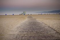 Path on sandy beach with lifeguard in California, USA — Stock Photo