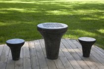 Shaped chess table and stools on wooden deck at city park — Stock Photo