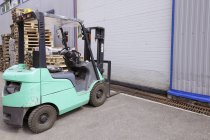 Electric forklift machinery working in warehouse — Stock Photo