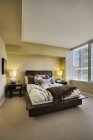 Luxury bedroom in modern highrise apartment — Stock Photo