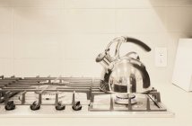 Stainless steel tea kettle on stove — Stock Photo