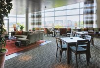 Clubhouse tables and seats in highrise hotel — Stock Photo