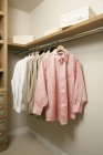 Closet inside with hanging shirts in apartment — Stock Photo