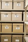 Boxes of invoices stacked on shelves — Stock Photo