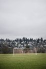 Goal nets on soccer field in town landscape — Stock Photo