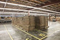 Flattened cardboard boxes in warehouse — Stock Photo