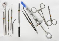 Dental instruments on white surface, top view — Stock Photo