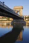 Chain bridge spanning river, Budapest, Hungary — Stock Photo