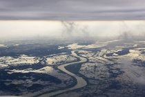Aerial view of river running through flooded countryside, Narita, Japan — Stock Photo