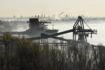 Commercial dock and factory in misty landscape — Stock Photo