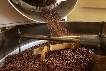 Coffee beans roasting in industrial kettle — Stock Photo