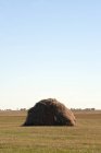 Large hay stack in countryside field — Stock Photo