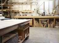 Wood, workbenches and tools in industrial carpentry workshop — Stock Photo