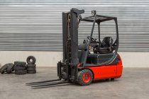 Forklift machinery parked in warehouse interior — Stock Photo