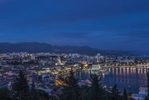 Aerial view of illuminated dock and cityscape of coastal town, Split, Croatia — Stock Photo