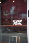 Close-up of open sign on glass cafe door — Stock Photo