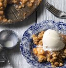 Close-up of Dutch apple pie and ice cream on wooden table — Stock Photo
