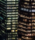 Illuminated highrise buildings with offices at night — Stock Photo