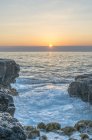 Sunrise over rock formation on beautiful beach, Mokolea Point, Hawaii, USA — Stock Photo