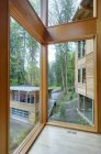 Glass windows of modern house in countryside forest — Stock Photo