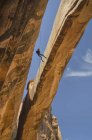 Rock climber hanging on rope on arch, Moab, Utah, USA — Stock Photo