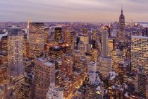 Vista aérea de edificios de gran altura en paisaje urbano al atardecer - foto de stock