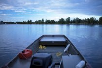 Fishing boat on still rural lake — Stock Photo