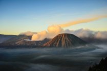 High angle view of clouds under smoking volcano — Stock Photo