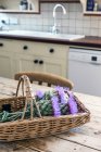 Basket of flowers in rustic domestic kitchen — Stock Photo