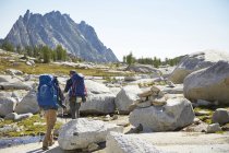 Hikers backpacking in rocky rural landscape — Stock Photo