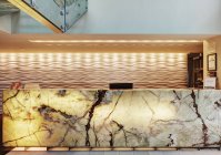 Marble reception desk in luxury hotel lobby — Stock Photo