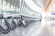 Close-up of wheels of stacked airport carts — Stock Photo