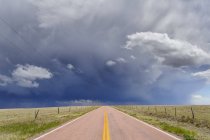 Storm clouds over open road, Rush, Colorado, United States — Stock Photo