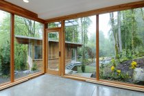 Glass windows of modern house in countryside forest — Stock Photo