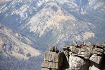 People hiking on rocky hilltop, Washington, USA — Stock Photo