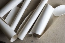 High angle close-up of rolls and cut-offs of pieces of drawing paper. — Stock Photo