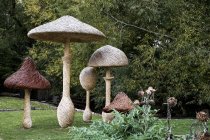Tall wooden carved toadstools garden sculptures in Oxfordshire, England — Stock Photo