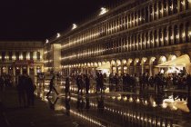 Illuminated facade of Procuratie Nuove in St Marks Square in Venice, Veneto, Italy at night. — Stock Photo
