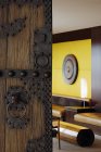 Open wooden ornate door to living room of house — Stock Photo