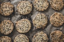 Close-up of fresh seeded crackers on baking tray. — Stock Photo