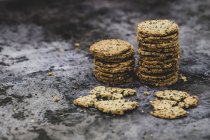 High angle close-up of stacks of freshly baked seeded crackers. — Stock Photo