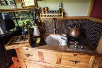 Interior view of camper van with small cooking area and sink. — Stock Photo