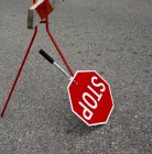 Handheld stop sign on asphalt road, close-up — Stock Photo