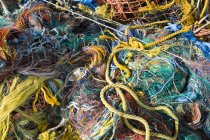 Pile of fishing nets in various colors, full frame — Stock Photo