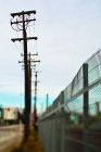 Fencing and power poles in selective focus, San Francisco, California, United States — Stock Photo