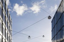 Office buildings exterior with cables against blue sky with clouds — Stock Photo