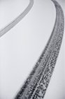 Tire tracks in white snow covered road surface, full frame — Stock Photo