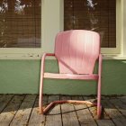Рожевий металевий стілець на будівельному ганку — стокове фото