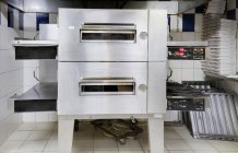 Pizza oven in modern restaurant kitchen — Stock Photo