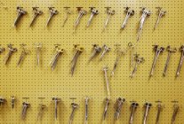 Yellow patterned wall of surgical clamps — Stock Photo